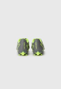 Football boots in gray with bright yellow accents. Textured upper, prominent branding on the heel, and yellow studs for traction.