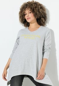 Graues Langarmshirt mit V-Ausschnitt, mit gelbem Text "ALLES hat Schönheit." Gerundeter Saum und lockere Passform.