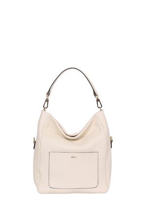 Cream leather handbag with a slouchy design, single shoulder strap, front pocket outlined in black, and gold-tone hardware accents.