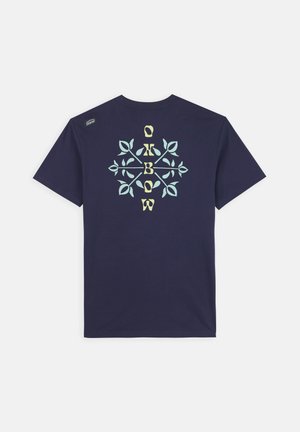 T-shirt en coton bleu marine avec un design graphique de feuilles et le mot "O'BOW" en couleurs claires au dos, manches courtes et col rond.