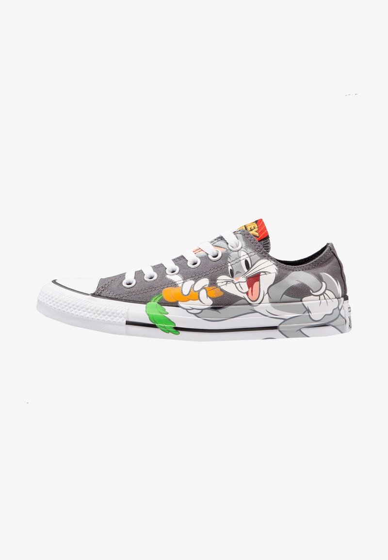 Sneakers in tela grigia con suola in gomma bianca, con una grafica di Bugs Bunny che tiene una carota sul lato, e lacci bianchi.