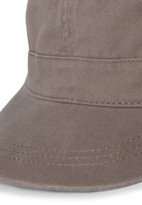 Brown cotton hat with a structured crown, curved brim, and visible stitching details. Fabric has a fine ribbed texture.