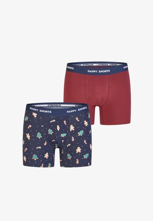 Two pairs of men's boxers: one solid burgundy and the other navy with festive patterns of gingerbread men and Christmas trees, both with a blue waistband.