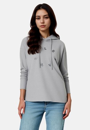 Hellgrauer Hoodie mit entspanntem Schnitt, mit verstellbarer Kapuze und gedruckten Akzenten in kreisförmiger Anordnung. Kombiniert mit hellblauen Jeans.