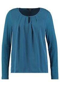 Teal pitkähihaista paitaa pehmeästä kankaasta, jossa on pyöreä pääntie, poimutusdetaljointi ja pieni avaus edessä.