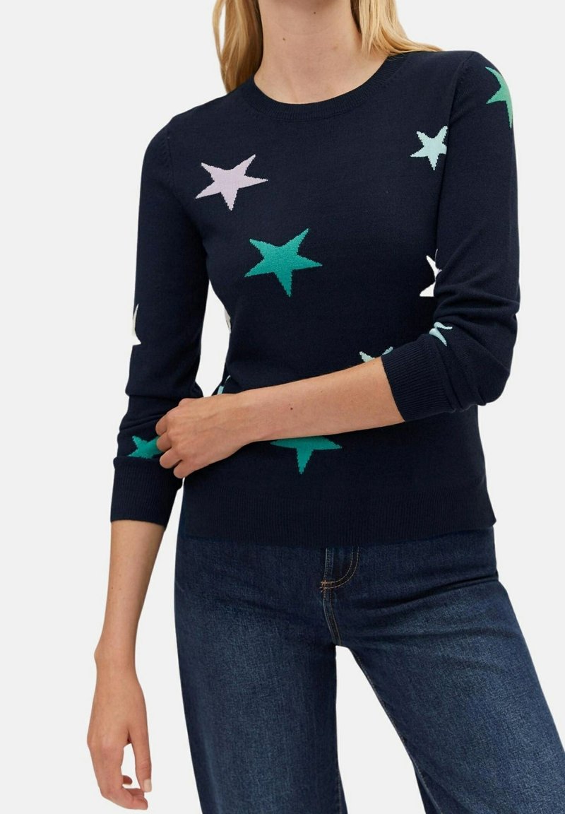 Navy knit sweater featuring colorful star patterns in light green, teal, and pale pink, with long sleeves and a round neckline.