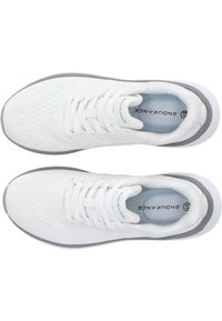 White athletic shoes with a textured mesh upper, flat laces, and gray accents. Features a cushioned insole and a rubber outer sole.