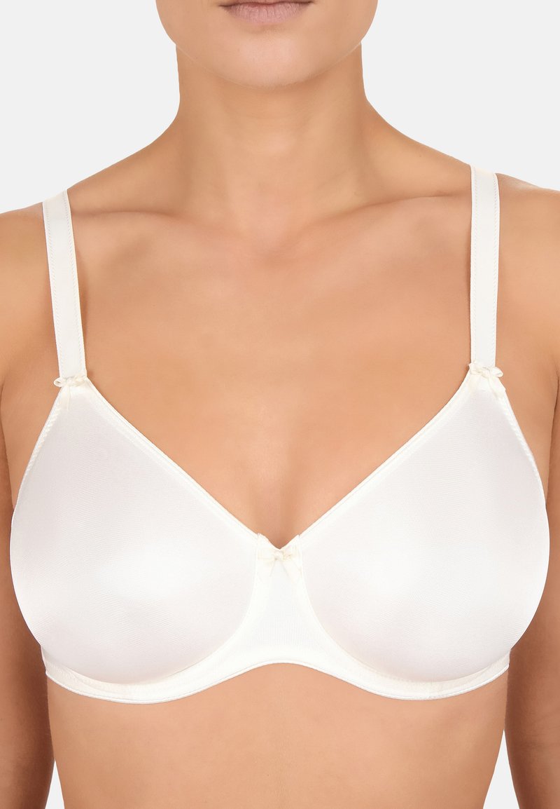 Sottile reggiseno color crema con tessuto liscio, supporto con ferretto e spalline regolabili. Presenta piccoli fiocchi decorativi alla base delle spalline.