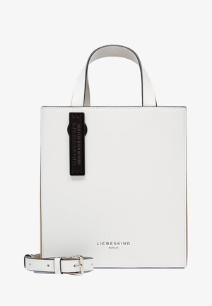 White leather square handbag with short handles, detachable strap, and black embossed tag. Features a smooth texture and minimalistic design.