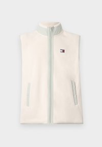 Sleevless fleece vest i myk krem med en lys grønn krage, frontlommel med glidelås, og to sidelommer. Har et lite logo-patch.