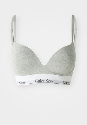 Szary braletka o gładkiej fakturze, z dekoltem w kształcie litery V, regulowanymi ramiączkami i białą taśmą z logo Calvin Klein.