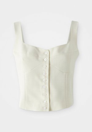 Krémový bezrukávový krCrop top s širokými ramínky a přední řadou malých bílých knoflíků uprostřed.