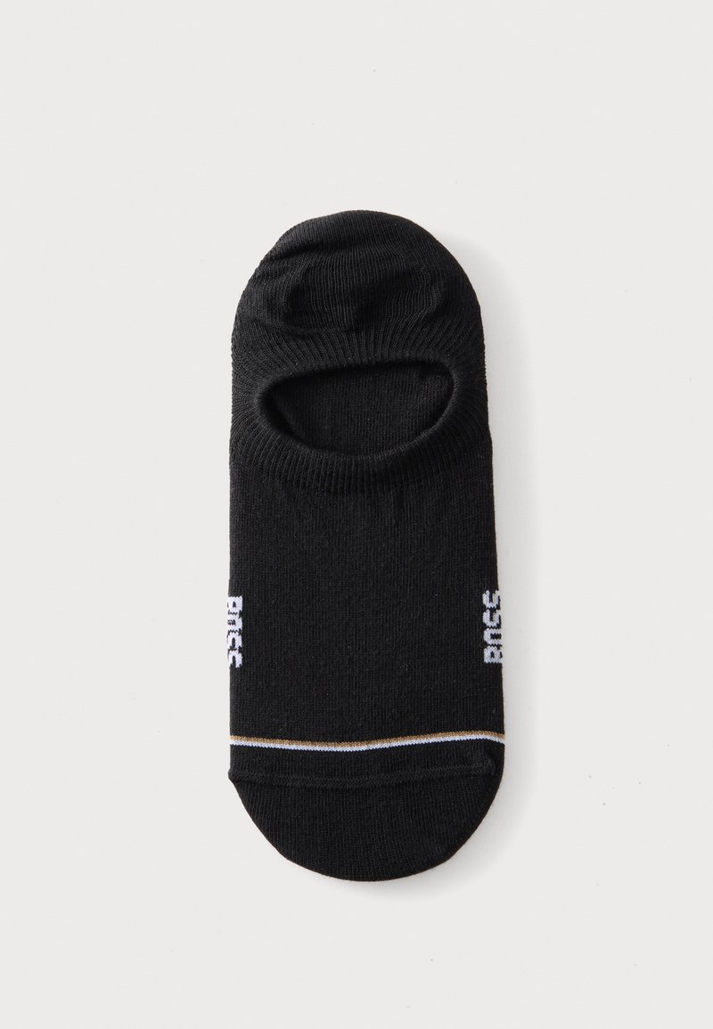 Chaussette invisible noire avec une bande blanche et dorée près des orteils et un texte blanc sur les côtés, présentée à plat sur fond blanc.