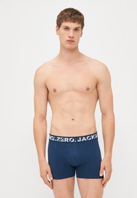 Herren Boxershorts in Marineblau mit einem breiten elastischen Bund, der mit weißem Text versehen ist. Der Stoff wirkt glatt und hat eine körpernahe Passform.