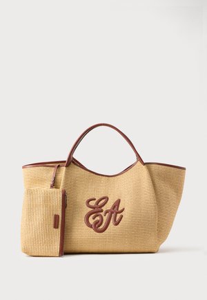 Woven straw tote bag with brown leather handles and trim, featuring a matching pouch and embossed "EA" initials on the front.