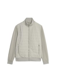 Giacca grigia chiara con corpo trapuntato e maniche lisce. Presenta un colletto rialzato, chiusura lampo anteriore e tasche laterali con zip.