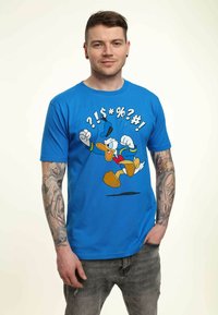 Blue cotton t-shirt featuring a cartoon duck in a colorful outfit with raised fists and text symbols. Short sleeves and round neckline.