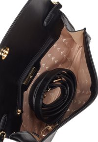 Black leather handbag with a smooth finish, gold hardware accents, and a light pink patterned interior. Includes a coiled strap inside.