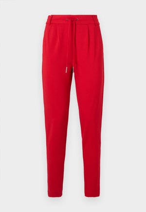 Pantalons rouges fuselés avec une taille élastique à cordon et des plis à l'avant, présentés sur un fond blanc.