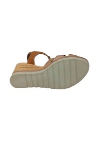 Sandalo con zeppa, con una strap in pelle color cuoio, parte superiore beige texturizzata e una suola intermedia in juta intrecciata. Suola esterna in gomma bianca con righe orizzontali. Taglia 38.