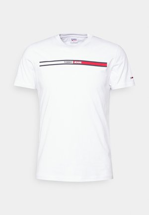 White cotton t-shirt featuring a horizontal design with red and black stripes. "TOMMY JEANS" logo printed at the center. Short sleeves.