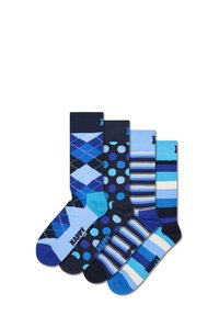 Quatre paires de chaussettes bleues de designs variés : argyle, pois et rayures. Les matériaux sont un mélange de coton. Comprend des accents de contraste au niveau des orteils et des talons.
