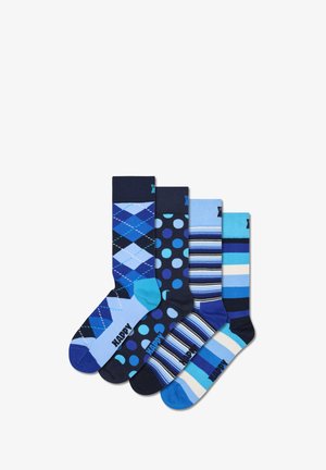 Vier Paare blauer Socken in verschiedenen Designs: Argyle, Polka Dots und Streifen. Materialien sind aus Mischbaumwolle. Mit kontrastierenden Zehen- und Fersenakzenten.