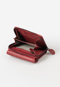 Red leather wallet with black zipper, featuring two card slots and a compartment for cash or coins, lined with a striped fabric.