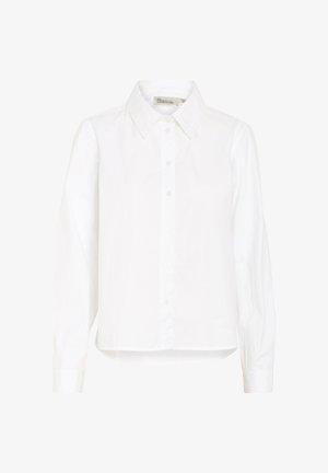 Balta marškinėliai su ilgomis rankovėmis, pagaminti iš lygaus medvilnės audinio. Turi klasikinę apykaklę, tiesų siluetą ir šiek tiek suapvalintą hemą.