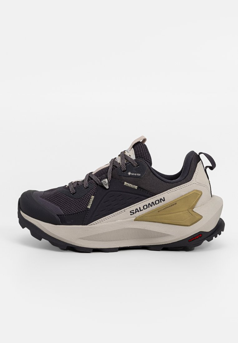Schwarze und graue Trailrunningschuhe mit Obermaterial aus Mesh, Gore-Tex-Marke, beiger Zwischensohle, strukturiertem Gummi-Außensohle und goldenen Akzenten an der Seite.
