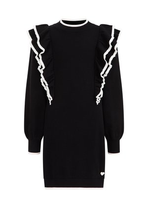 Czarna sukienka z długim rękawem, wykończona białą falbaną na ramionach oraz z małym białym serduszkiem w pobliżu dołu.