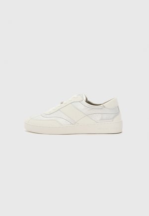 White sneakers with silver accents, featuring smooth leather, tonal stitching, round toe, and a flat sole. Branding on the heel.