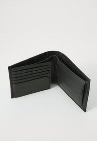 Black leather wallet opened to display multiple card slots, an ID window, and a smooth texture with subtle branding on the front.