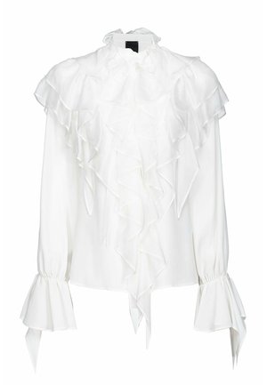 Blusa bianca con colletto alto arricciato, maniche lunghe e polsini svasati. Realizzata in un tessuto leggero e liscio.