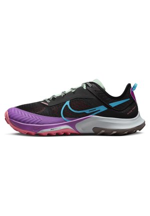 Black athletic shoe with purple and turquoise accents, mesh texture, thick sole, and reflective laces, designed for trail running.