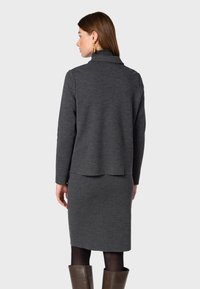 Gray knit jacket and pencil skirt set. The jacket features a fold-over collar and relaxed fit; the skirt is fitted to the knee.