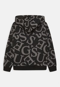 Felpa con cappuccio in tessuto nero con grandi lettere grigie su tutta la superficie. Presenta una vestibilità comoda e polsini e orlo a costine.