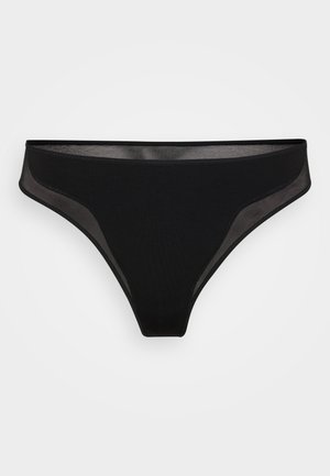Black thong underwear made from a smooth fabric with sheer mesh side panels, featuring a minimalist design and elastic waistband.