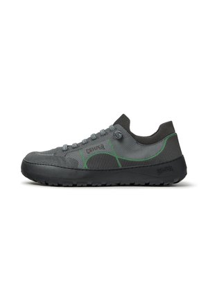Dark gray low-top sneaker with green trim, knit fabric upper, textured sole, and slip-on sock-style collar, shown from the side.