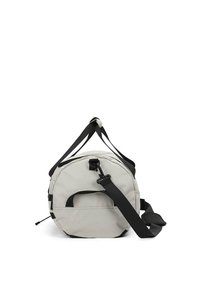Sac de sport rond en tissu gris clair, avec des sangles et des accents noirs. Comprend une poignée supérieure et une bandoulière réglable.