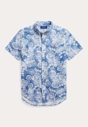 Chemise bleue à manches courtes avec motif floral blanc, col boutonné et logo Polo Ralph Lauren sur la poitrine.