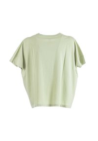 T-shirt a maniche corte, dalla vestibilità ampia, in cotone verde chiaro, con scollatura rotonda e texture morbida. Il design presenta una silhouette rilassata.