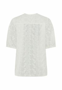 Hvid bluse med 3/4 ærmer med detaljeret blomstermønsterbroderi og en rygstykke-detalje.