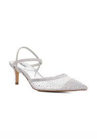 Clear pointed-toe slingback shoe in transparent mesh with silver trim, embellished with rhinestones and a slender kitten heel.