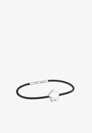 Black rubber bracelet with a stainless steel clasp and a polished four-leaf clover charm on a white background.