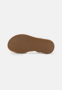 Brązowa gumowa podeszwa z wzorem antypoślizgowym, o zaokrąglonym kształcie i gładkich krawędziach, zaprojektowana z myślą o komforcie i trwałości.