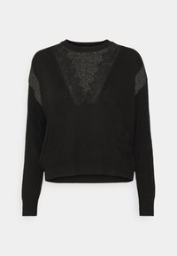 Pull noir à manches longues avec un panneau texturé scintillant sur la poitrine et des détails scintillants assortis sur le haut des manches.