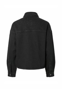 Veste en jean noire à manches longues, poignets boutonnés et petits détails perforés sur le haut du dos et les épaules.