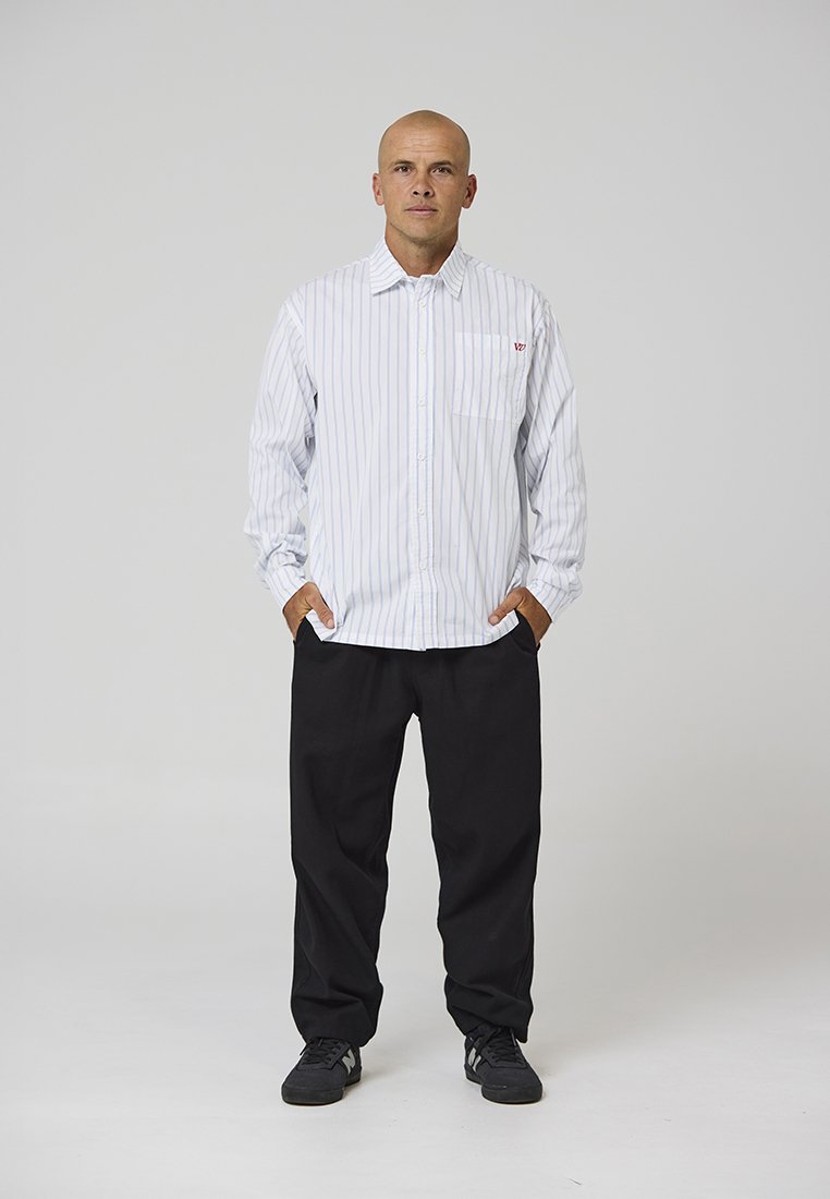 White button-up shirt with vertical blue stripes, featuring a left chest pocket and small red logo; paired with black pants and black shoes.