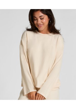 Cremfarbener Pullover mit langen Ärmeln, rundem Ausschnitt und samtiger Textur. Verfügt über eine lockere Passform mit seitlichen Schlitzen am Saum.